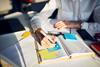 Cropped image of a smartly dressed woman writing in a weekly planner