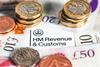 Image of coins on top of a HMRC document