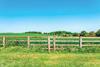 A fence cutting across a field