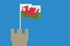 A Welsh flag flies from the top of a castle tower