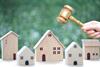 Property auction, Woman hand holding gavel wooden and model house on natural green background