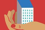 A hand holds a small building in its palm, with code showing in several windows