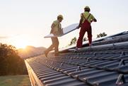 men putting solar panel on roof 