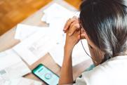 A stressed woman looking at bills