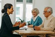 Smiling solicitor advising elderly clients