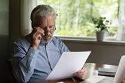 elderly-man-reading-document-drafting-will-1305359960