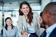 A successful candidate shakes hands with new colleagues at interview