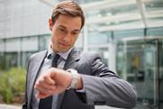 man-looking-at-wrist-watch-checking-time-521811061