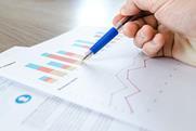 Hand with pen over bar chart results