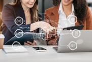 Two women look at AI