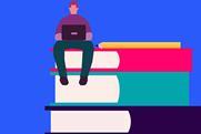 A person sitting on top of a stack of three large books, using a laptop. There is also a pencil placed horizontally across the top book. The background is blue, and the books are red, teal and purple, from top to bottom