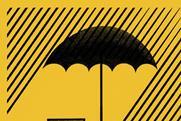 Insurance - umbrella sheltering broker's desk from rain