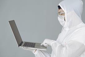 using-laptop-protective-gear-mask-coronavirus-600x400