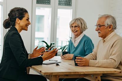 Smiling solicitor advising elderly clients