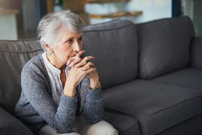 grieving-widow-stares-into-distance-1039521272