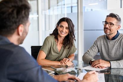 Smiling clients at meeting with solicitor