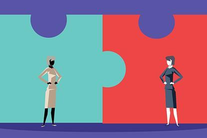 Two giant, connected jigsaw pieces with two women standing in front looking at each other