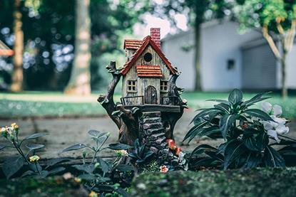 Miniature house ornament in garden