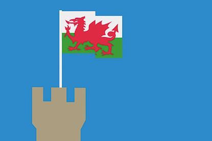 A Welsh flag flies from the top of a castle tower