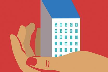 A hand holds a small building in its palm, with code showing in several windows