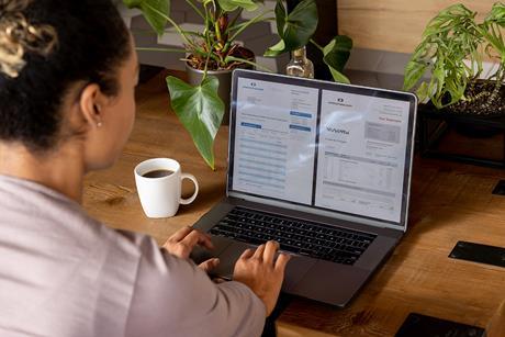 Woman checking a bank statement on a laptop
