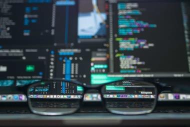 glasses-in-front-of-coding-screen-on-laptop-380x254