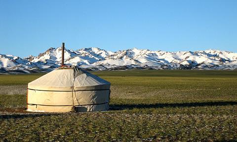 A photo of a yurt in the Mongolian grasslands
